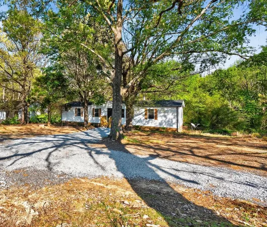a view of a house with swimming pool and sitting area