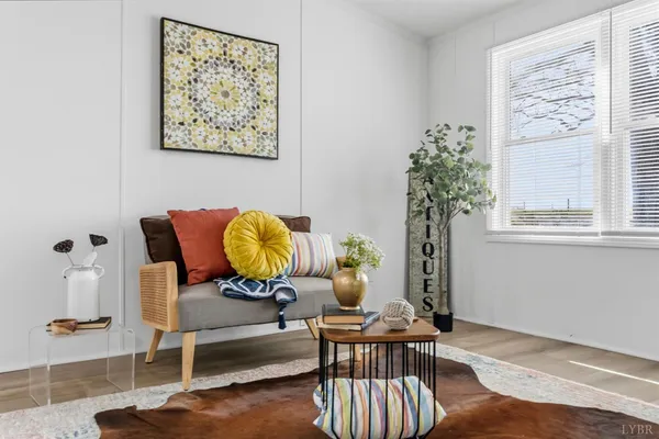 a living room with furniture and a potted plant