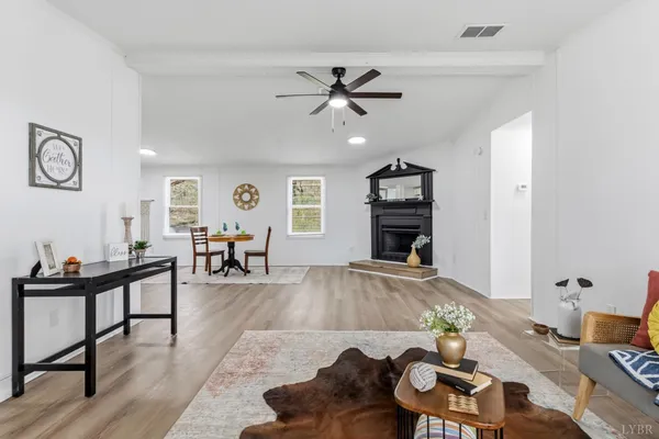 a living room with furniture and wooden floor