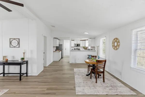 a view of a dining room with furniture and a window
