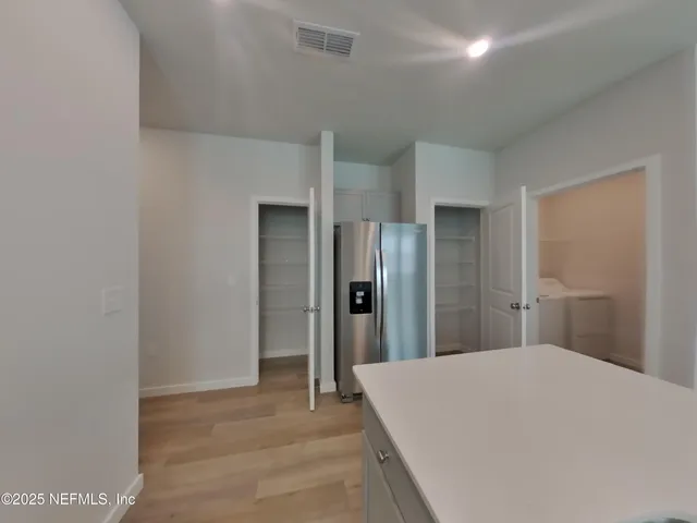 a large white bed in a white room