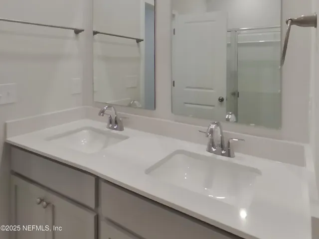 a bathroom with a sink and a large mirror