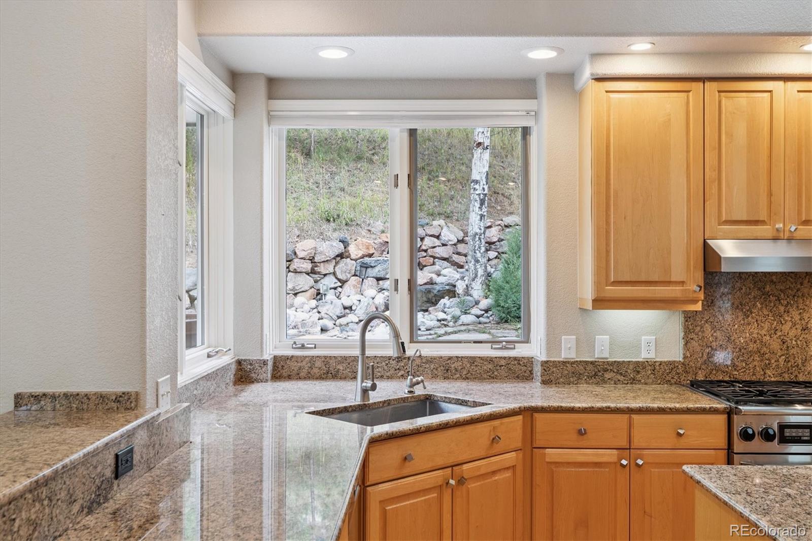 981 Sleepy Hollow Road Golden, CO 80401 - Photo 14 of 50 a kitchen with granite countertop a sink and a window