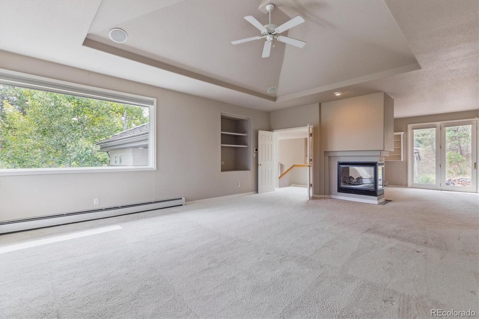 981 Sleepy Hollow Road Golden, CO 80401 - Photo 21 of 50 a view of empty room with fireplace and windows