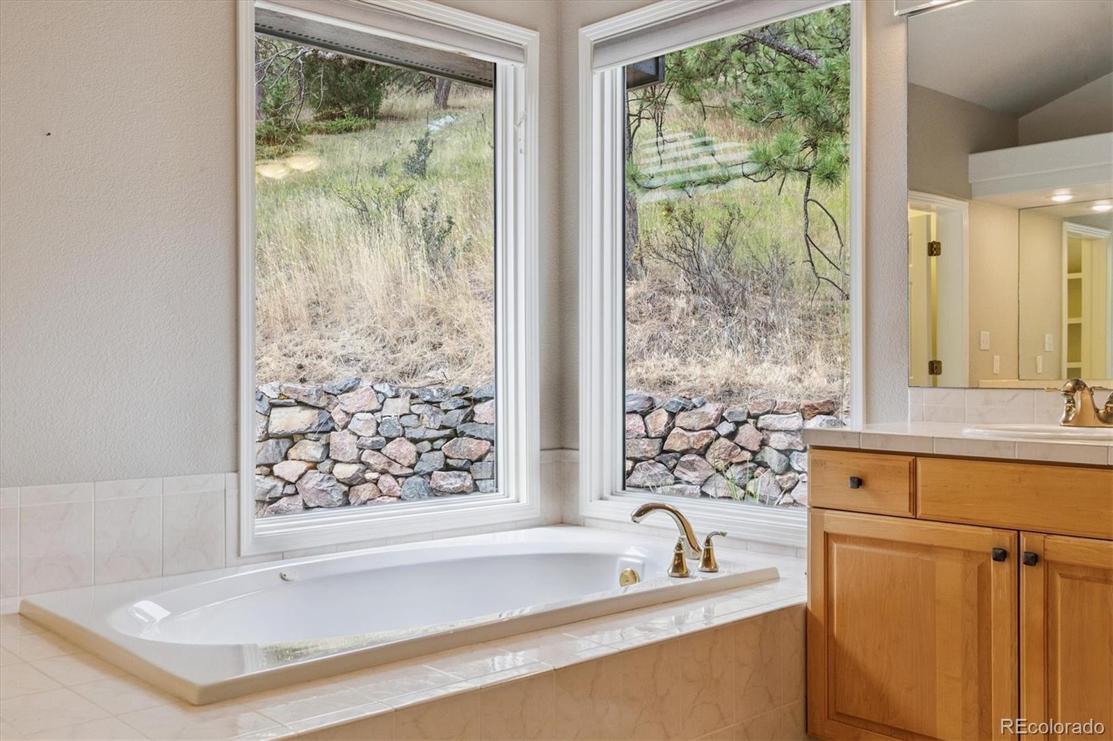 981 Sleepy Hollow Road Golden, CO 80401 - Photo 26 of 50 a bathroom with a bathtub and sink