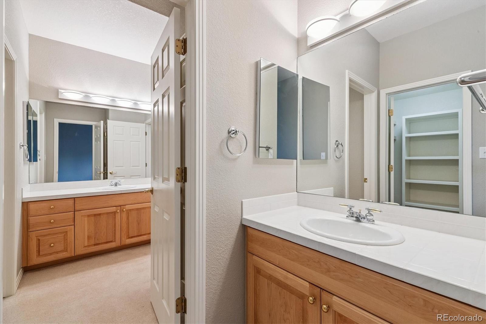 981 Sleepy Hollow Road Golden, CO 80401 - Photo 37 of 50 a bathroom with a granite countertop sink and a mirror