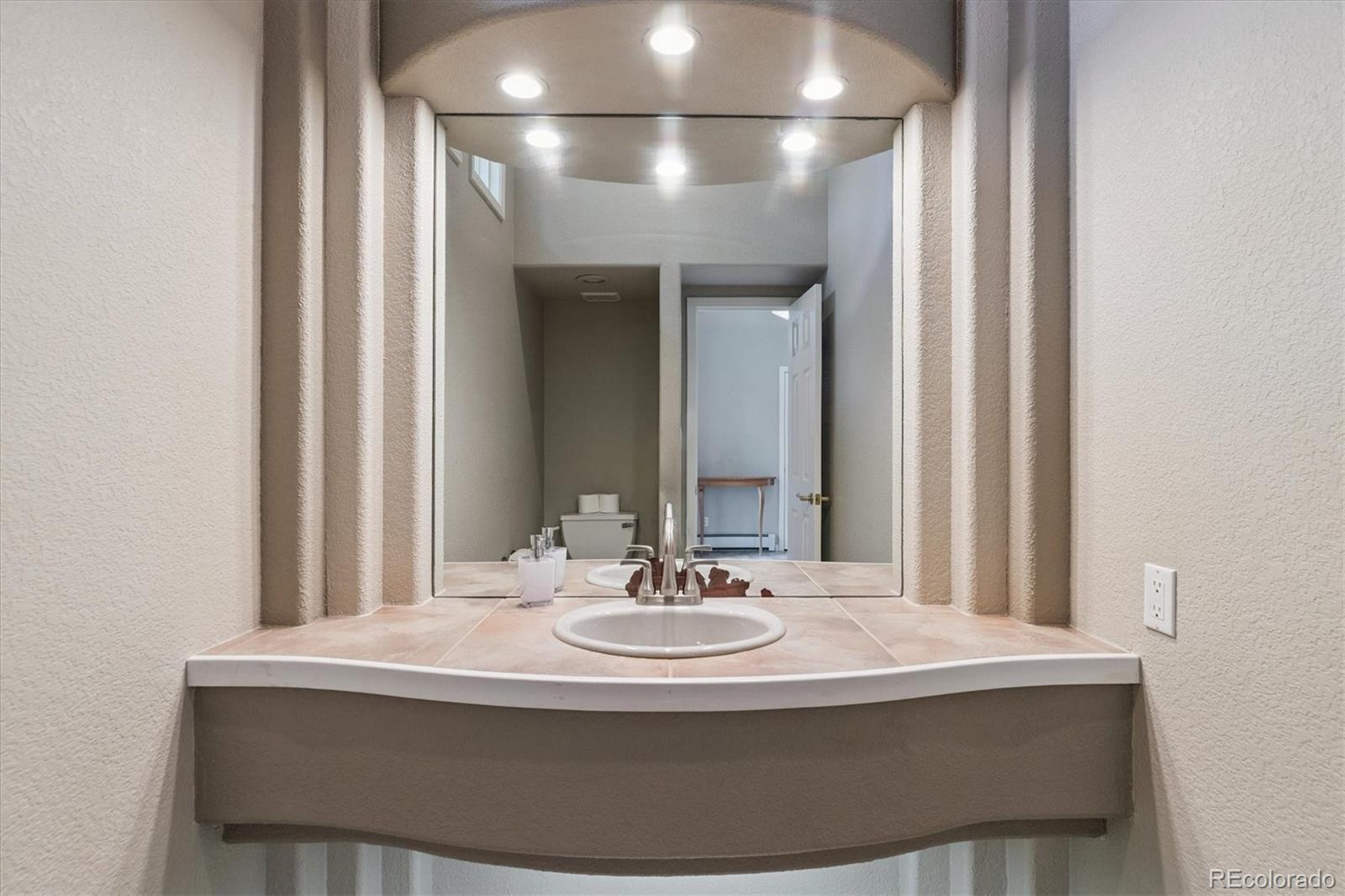 981 Sleepy Hollow Road Golden, CO 80401 - Photo 4 of 50 a bathroom with a sink and a mirror