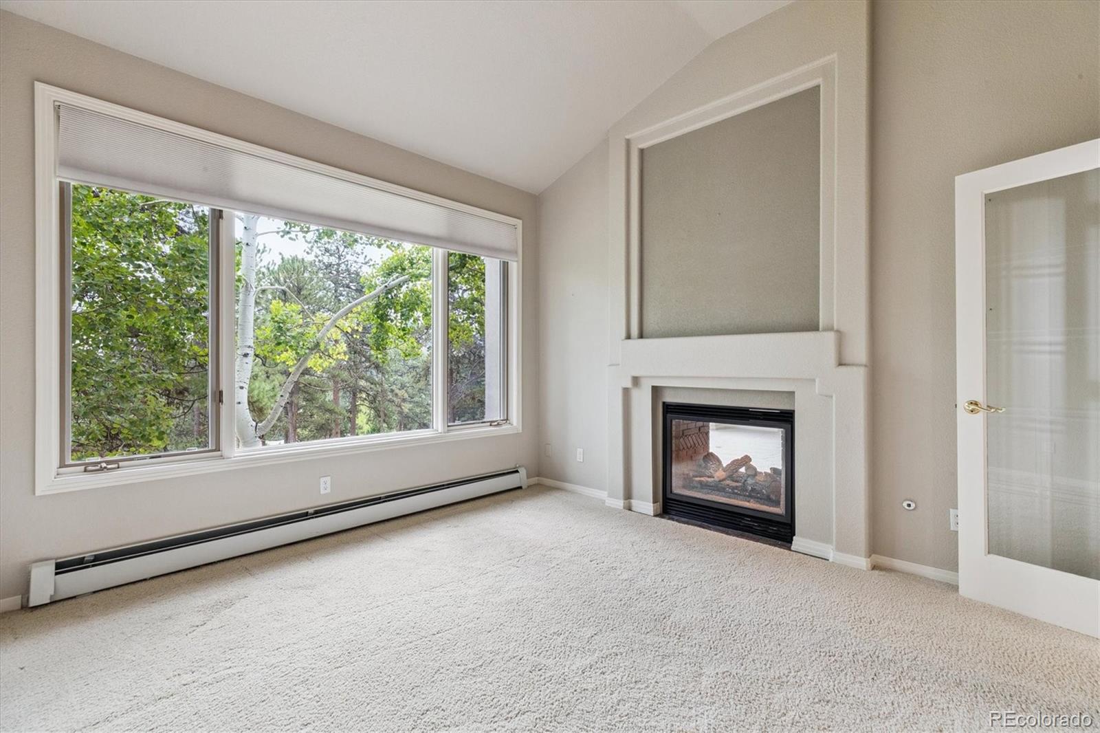 981 Sleepy Hollow Road Golden, CO 80401 - Photo 5 of 50 a view of an empty room with a window and fire place