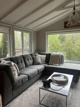a living room with furniture and a large window