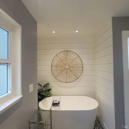 a bathroom with a bathtub and a window