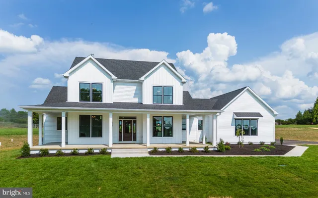 a front view of a house with a yard table and chairs