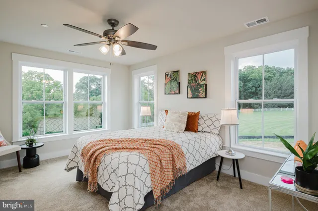 a bedroom with a large bed and a chandelier