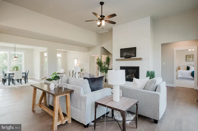 a kitchen with kitchen island granite countertop lots of counter top space a sink a stove and a window