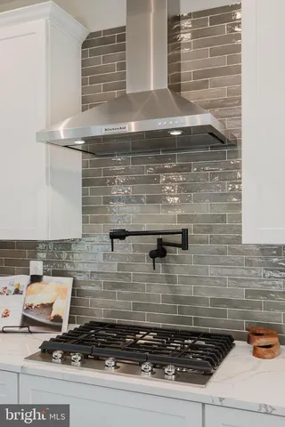 a kitchen with stainless steel appliances granite countertop a kitchen island a stove a table and chairs in it