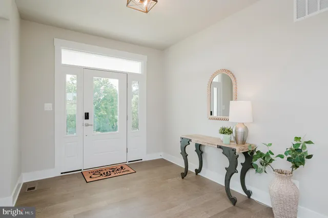 a dining room with furniture window and wooden floor