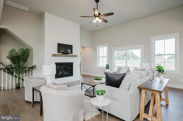 a living room with furniture and kitchen view