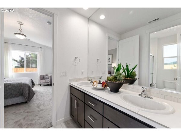313 West 19th Street Lafayette, OR 97127 - Photo 14 of 18 a en suite bathroom with double vanity sinks and a mirror