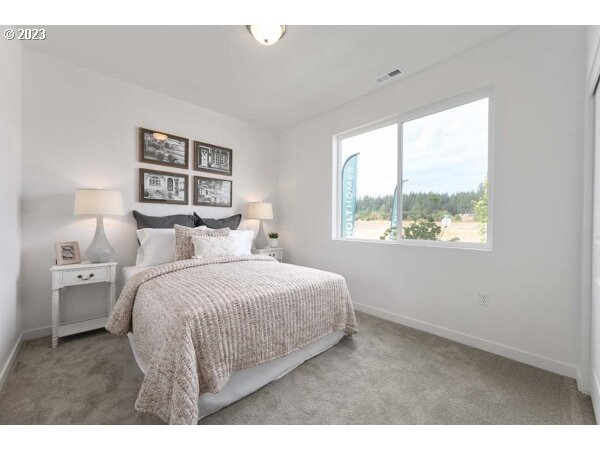313 West 19th Street Lafayette, OR 97127 - Photo 15 of 18 a bedroom with a bed and a painting on the wall