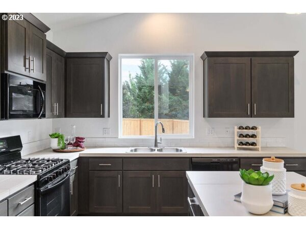 313 West 19th Street Lafayette, OR 97127 - Photo 6 of 18 a kitchen with a sink a stove and cabinets