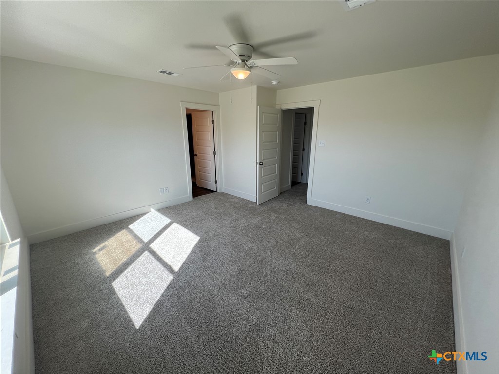 1822 Royal Loop Belton, TX 76513 - Photo 17 of 22 an empty room with windows and ceiling fan