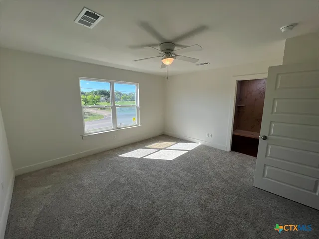 an empty room with windows and closet