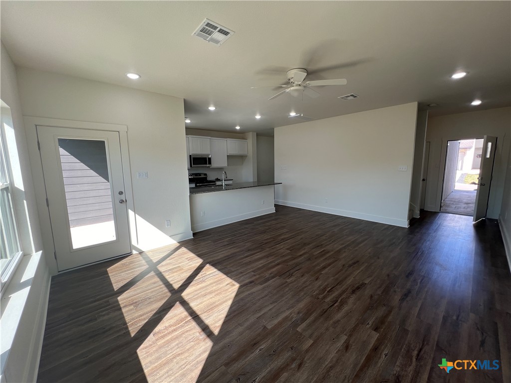 1822 Royal Loop Belton, TX 76513 - Photo 8 of 22 a view of a living room with wooden floor and a kitchen