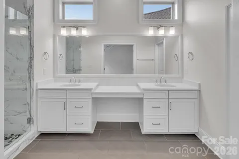 a bathroom with a sink vanity and mirror