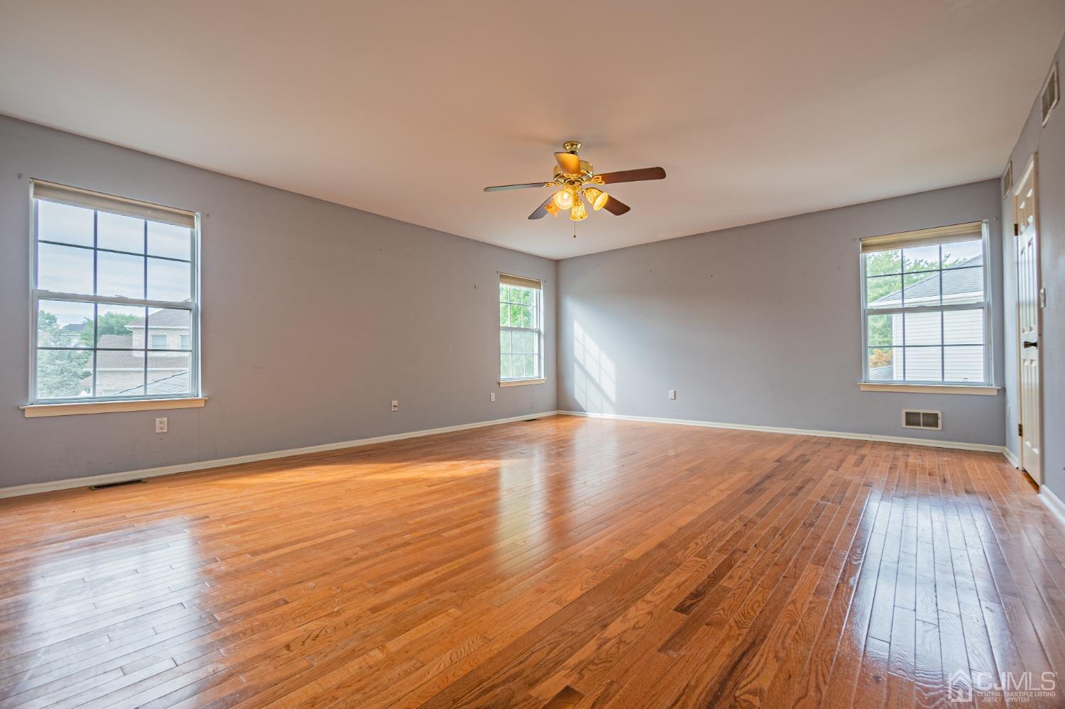 6 Sarah Court Edison, NJ 08817 - Photo 13 of 34 a view of an empty room with a window and wooden floor