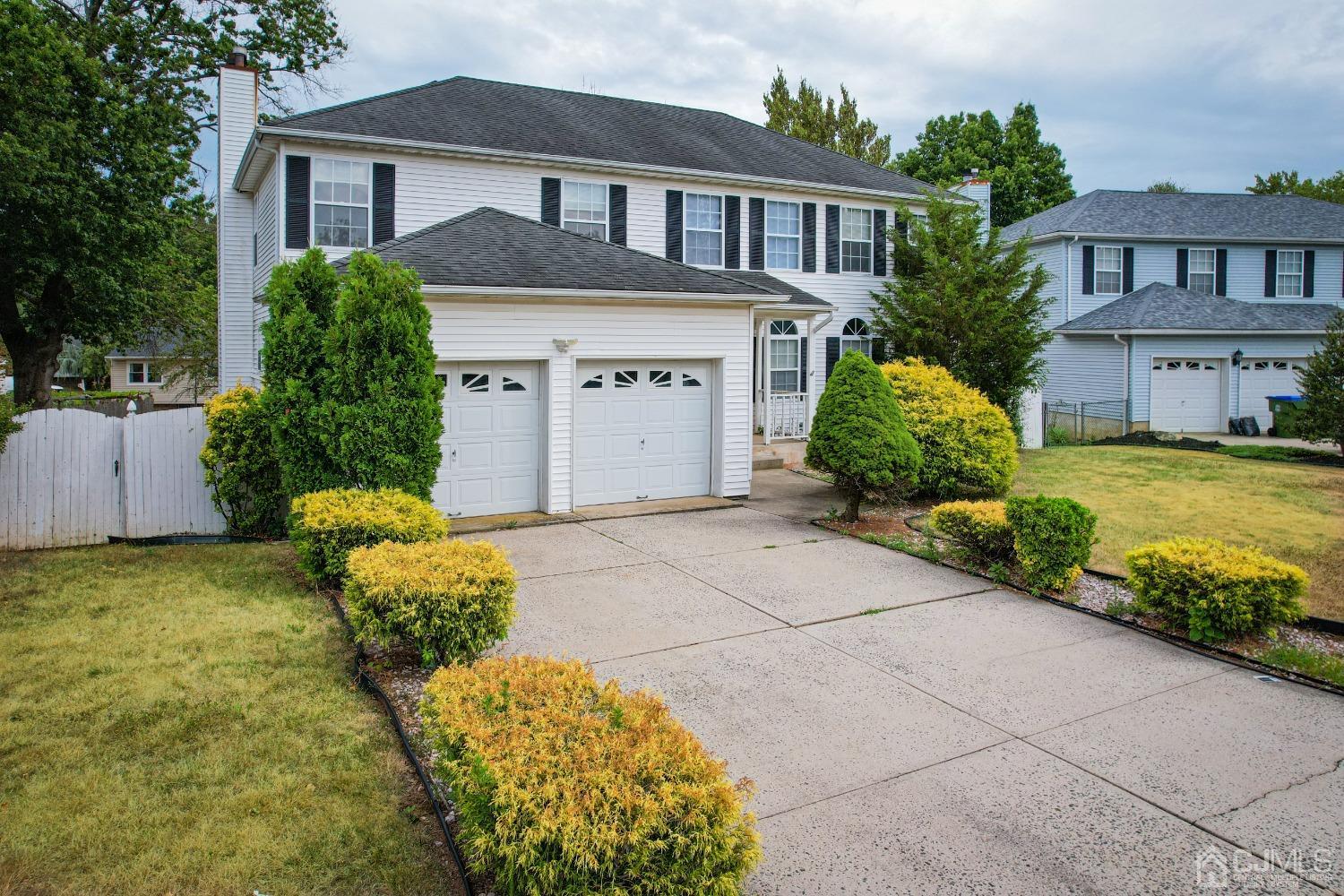 6 Sarah Court Edison, NJ 08817 - Photo 2 of 34 a front view of a house with a yard and garage