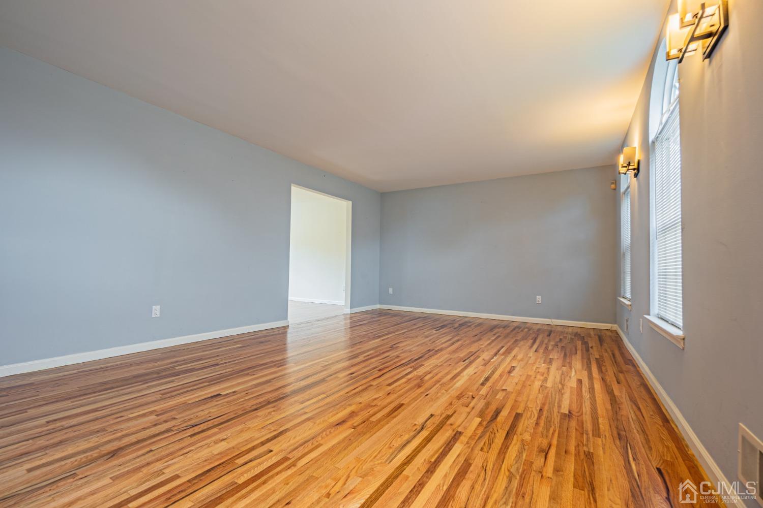 6 Sarah Court Edison, NJ 08817 - Photo 3 of 34 a view of an empty room with wooden floor and a window