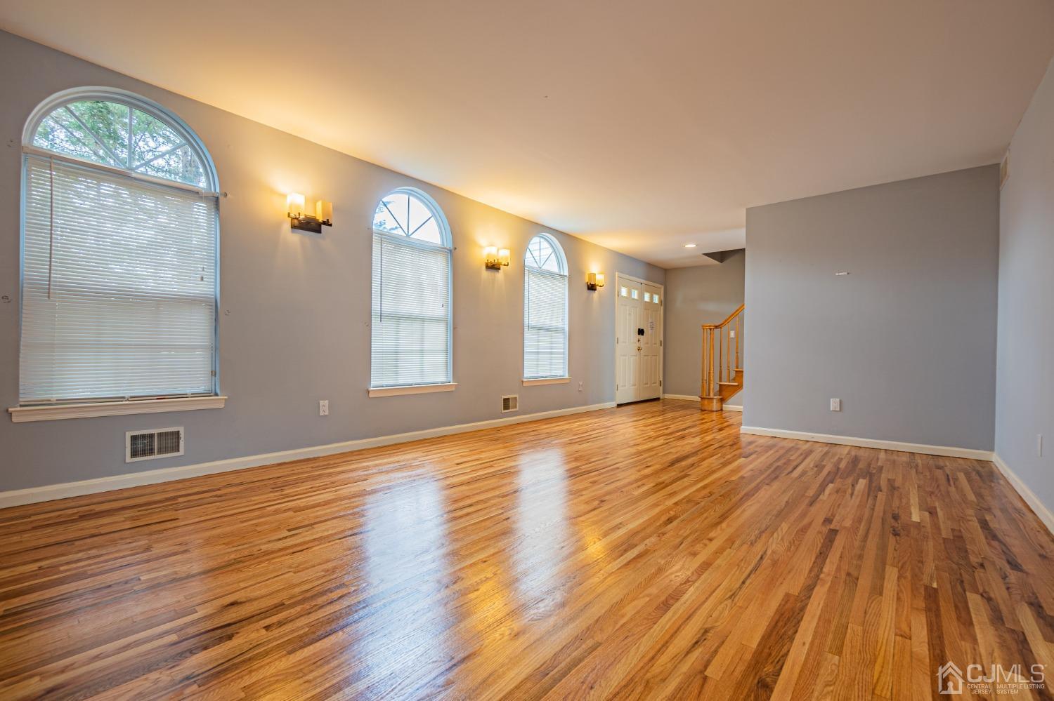 6 Sarah Court Edison, NJ 08817 - Photo 4 of 34 a view of an empty room with wooden floor and a window