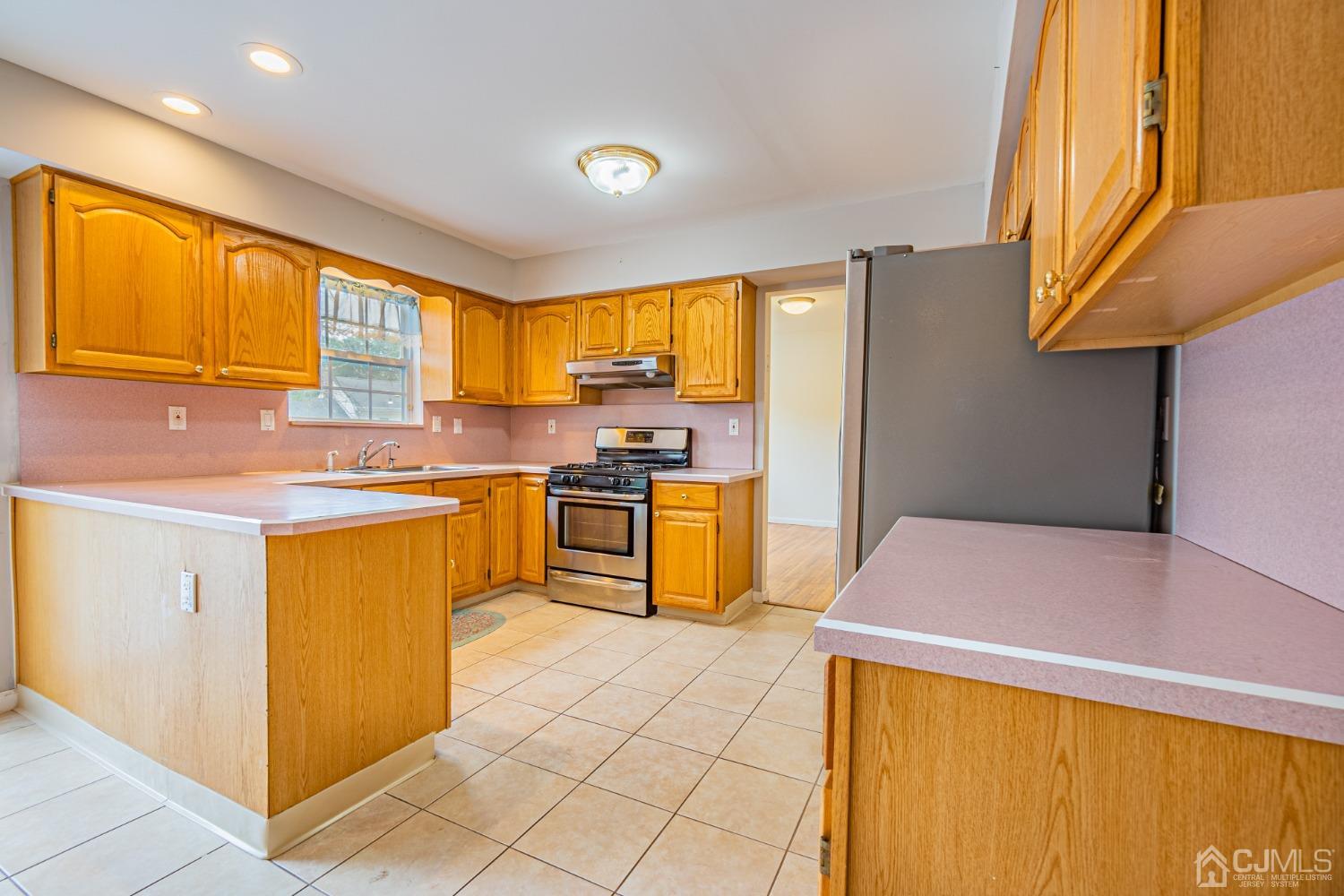 6 Sarah Court Edison, NJ 08817 - Photo 5 of 34 a kitchen with a stove a sink a microwave a counter top space and cabinets
