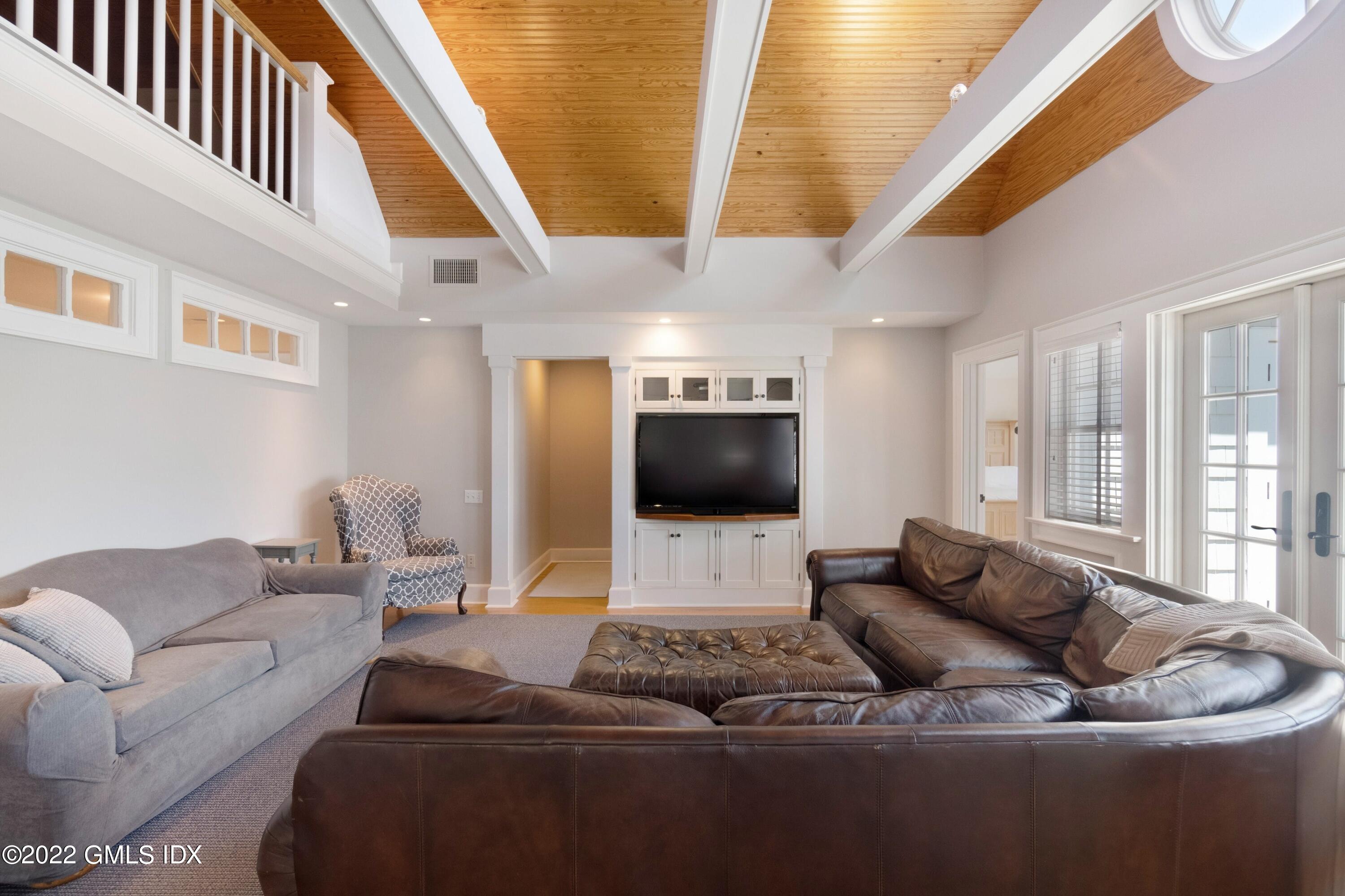 27 Willowmere Circle Riverside, CT 06878 - Photo 20 of 33 a living room with furniture and a flat screen tv