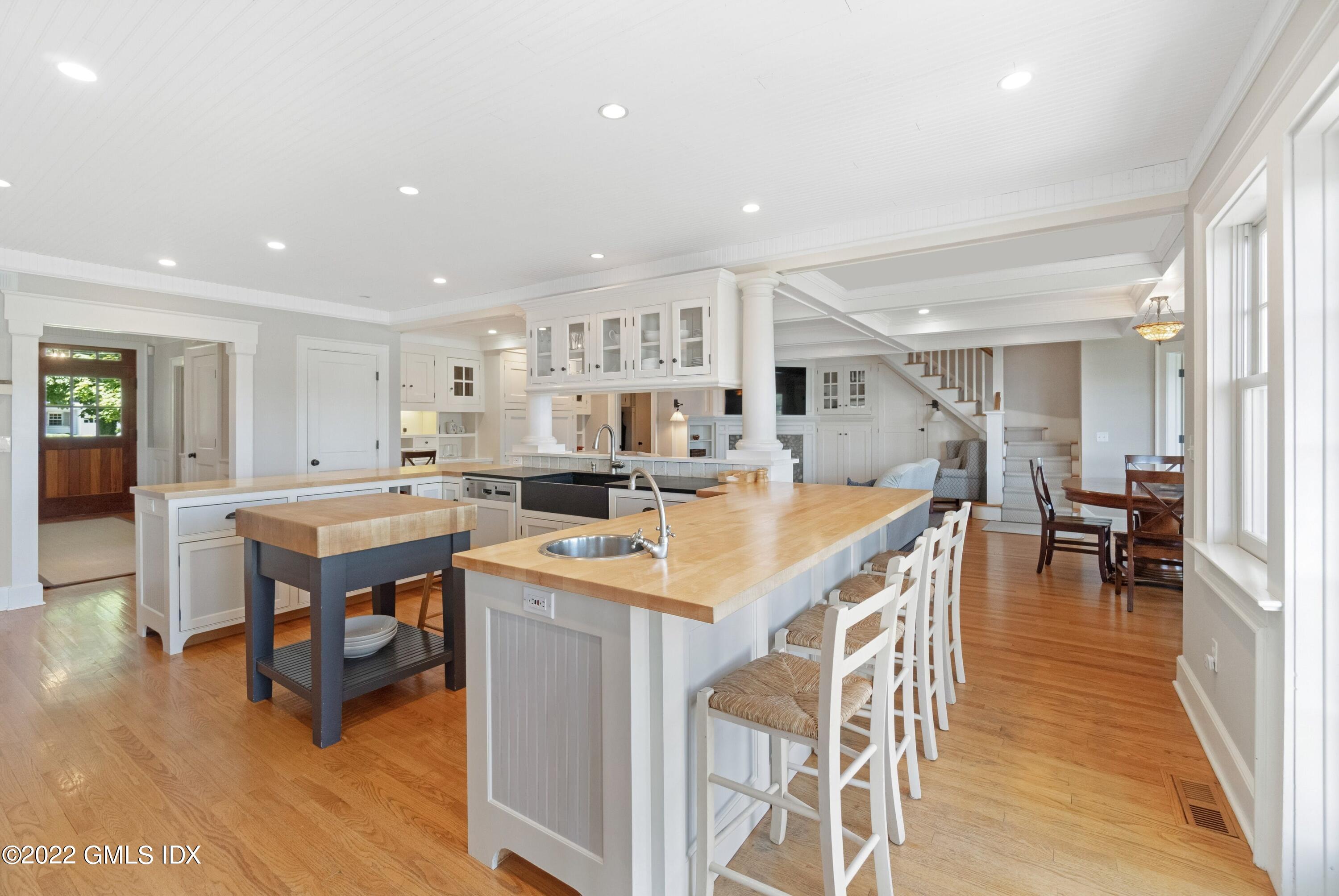 27 Willowmere Circle Riverside, CT 06878 - Photo 7 of 33 a kitchen with stainless steel appliances kitchen island granite countertop a table and chairs in it