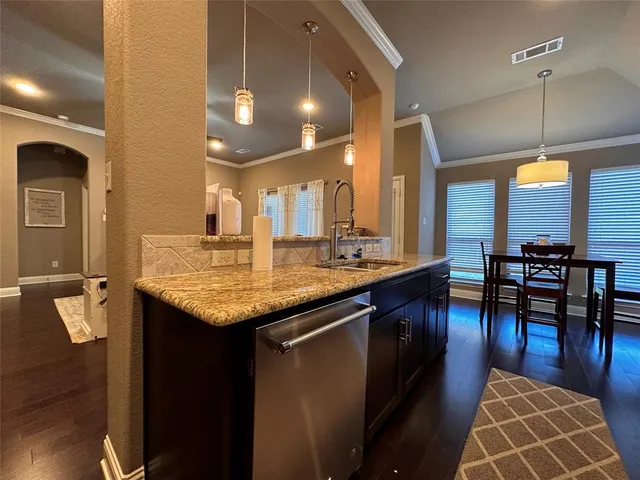 a kitchen with center island table and chairs