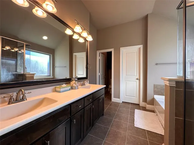 a bathroom with a double vanity sink and a mirror