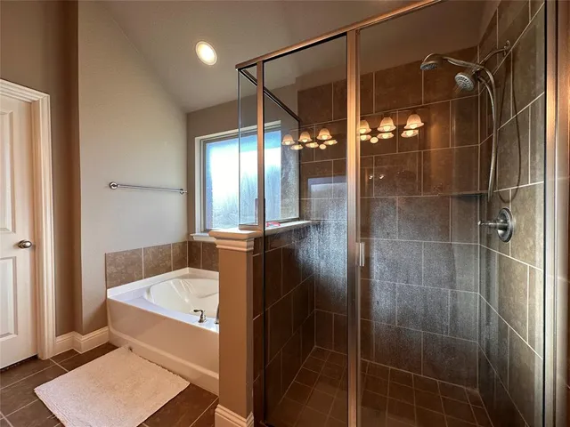 a bathroom with a tub and shower