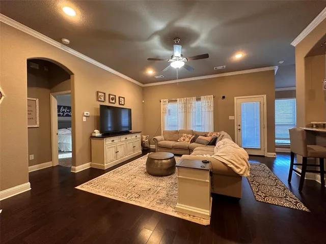 a living room with fireplace furniture and a flat screen tv