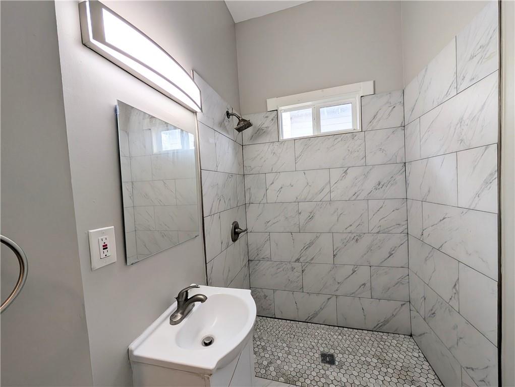 1716 Thompson Avenue Atlanta, GA 30344 - Photo 11 of 27 a bathroom with a sink a toilet and shower