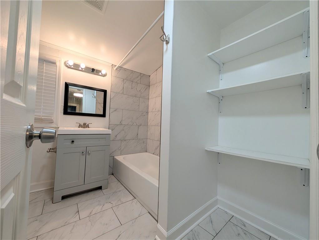 1716 Thompson Avenue Atlanta, GA 30344 - Photo 13 of 27 a bathroom with a toilet sink and mirror