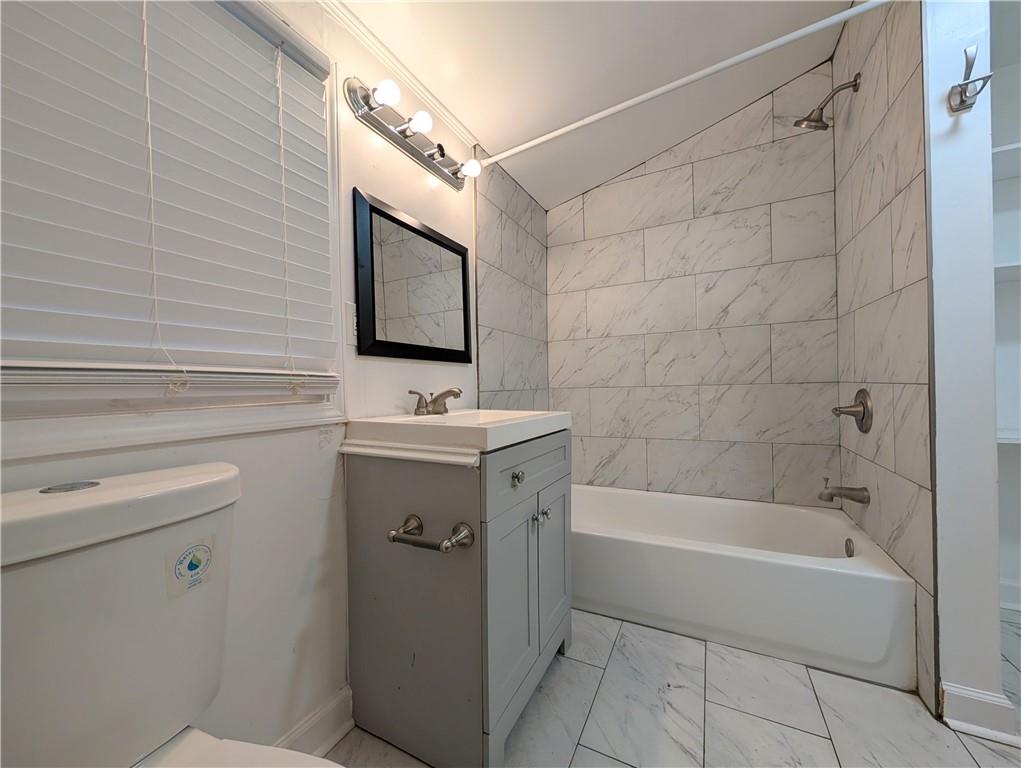 1716 Thompson Avenue Atlanta, GA 30344 - Photo 14 of 27 a bathroom with a sink a toilet and shower