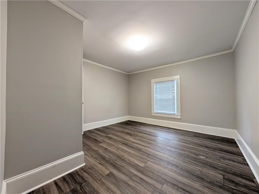 1716 Thompson Avenue Atlanta, GA 30344 - Photo 15 of 27 a view of an empty room with wooden floor and a window