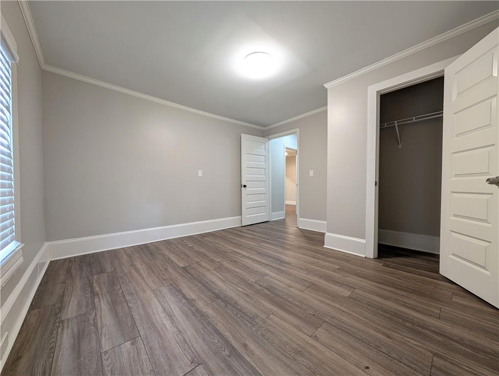 1716 Thompson Avenue Atlanta, GA 30344 - Photo 16 of 27 an empty room with wooden floor and windows