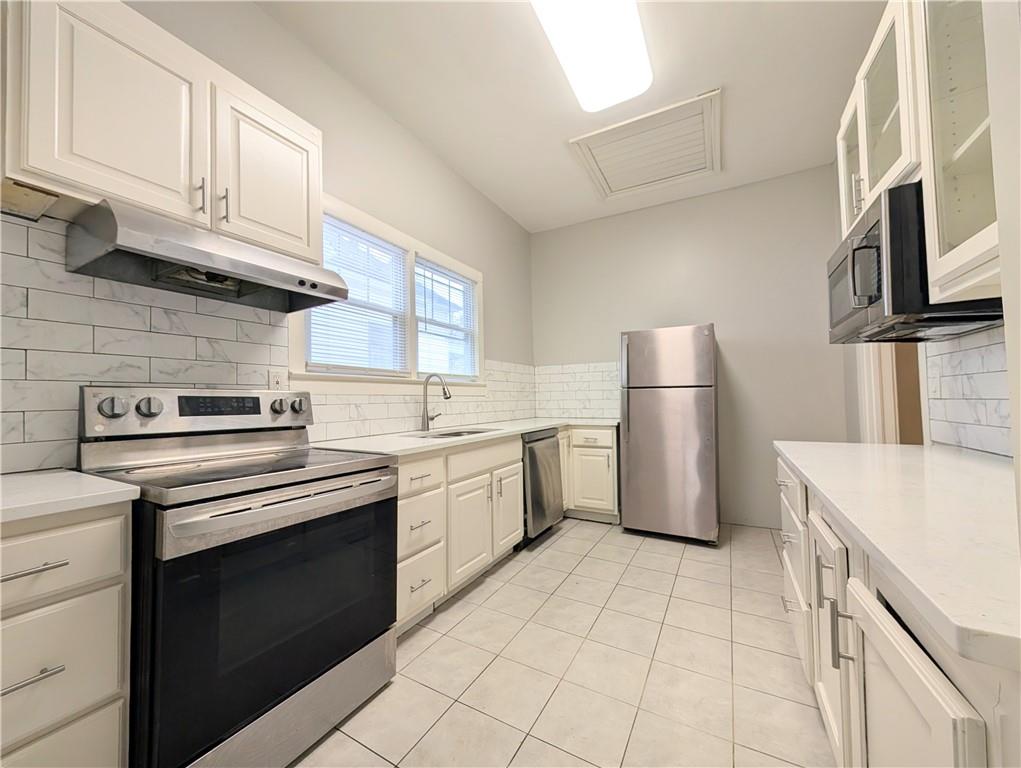 1716 Thompson Avenue Atlanta, GA 30344 - Photo 19 of 27 a kitchen with a sink stove and refrigerator