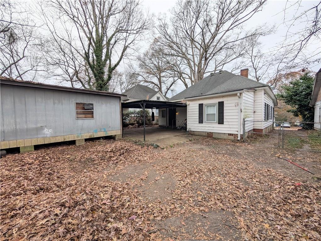 1716 Thompson Avenue Atlanta, GA 30344 - Photo 26 of 27 a house with trees in the background