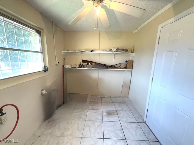 a room with stainless steel appliances a stove a refrigerator and cabinets
