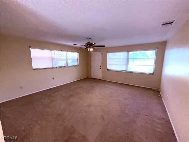 an empty room with a empty space and windows