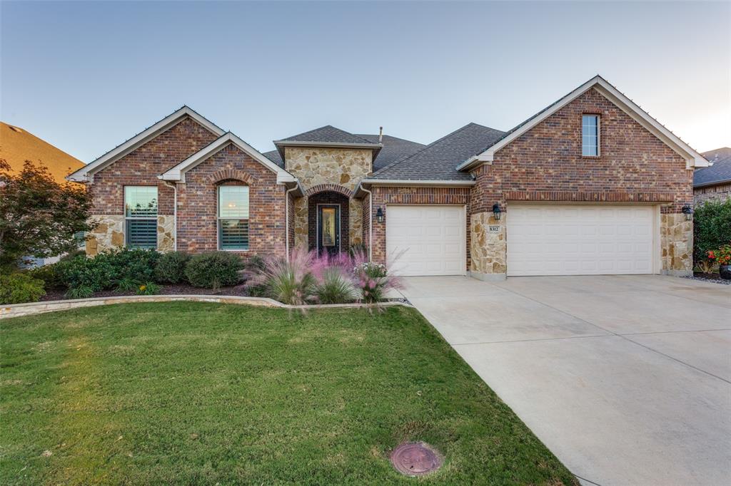8312 American Way Denton, TX 76207 - Photo 1 of 1 a front view of a house with a yard and garage