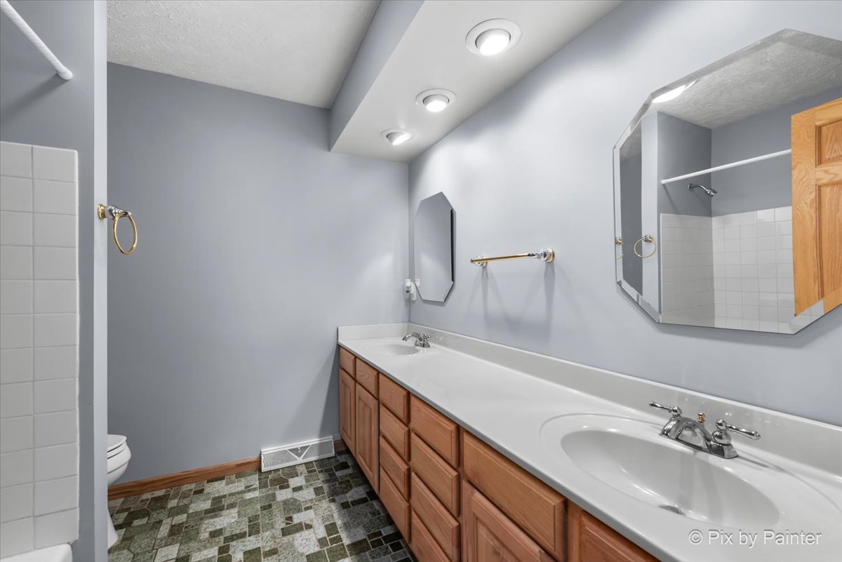 64 48w916 Il Route Maple Park, IL 60151 - Photo 23 of 62 a bathroom with a double vanity sink and a mirror