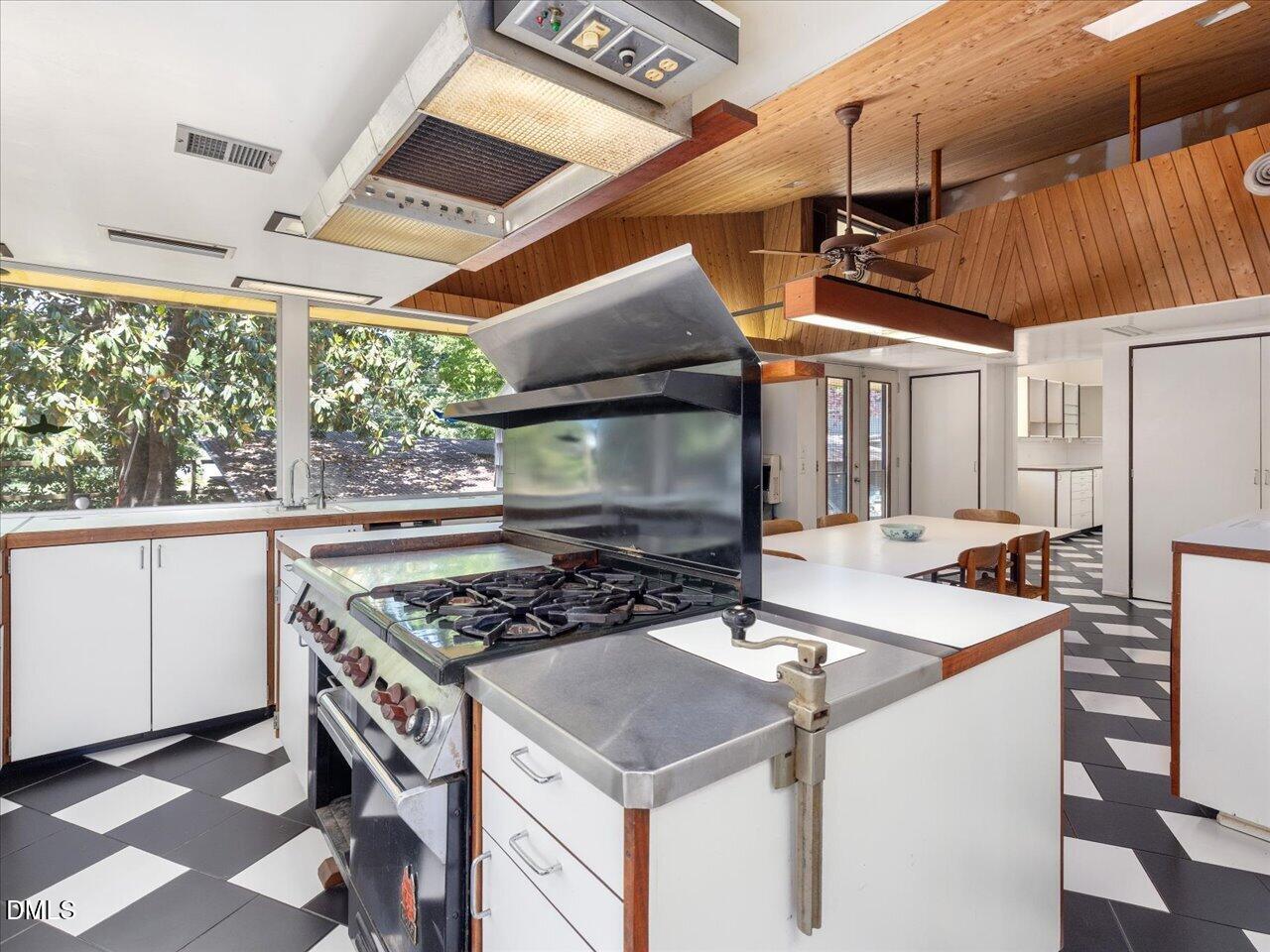 215 Hillcrest Road Raleigh, NC 27605 - Photo 47 of 97 a kitchen with a stove a sink and a refrigerator